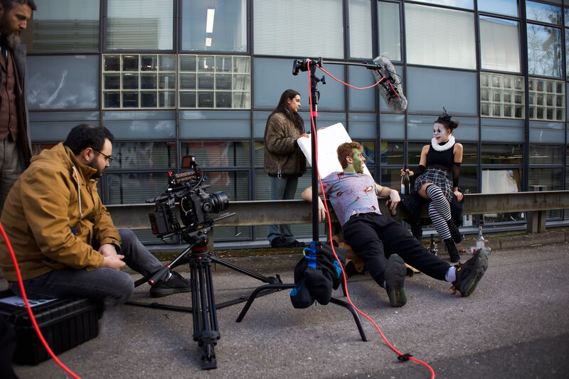 A group of students sitting in front of a camera.