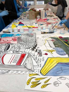 Students working on large colourful drawings