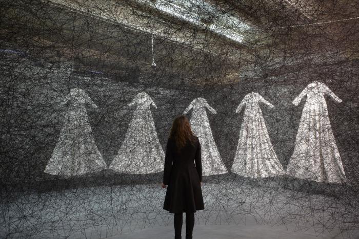 A visitor looks at a display at the Lost in Lace exhibition