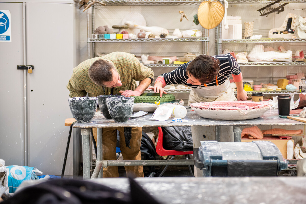 Two students working in a fine art studio